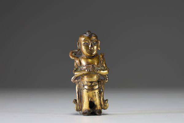 China - Ming period gilt bronze figurative statue of a servant.
