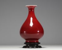 China - Oxblood porcelain vase, wooden base, 19th century.