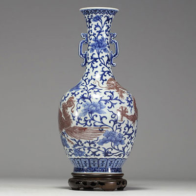 China - A white-blue porcelain vase decorated with a dragon and an iron-red phoenix, mark under the piece, 18th century.