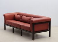 Jules WABBES (1919-1974) Three-seater sofa, black lacquered wood and red leather frame, brass base, circa 1960.