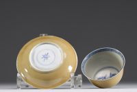 China - Bowl and plate in white-blue porcelain with floral decoration and exterior beige glaze, 18th century.