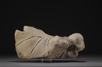 Piece of stone carved in the shape of a figure, on a base.