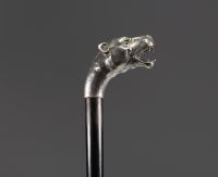 Art Deco silver cane with lioness head decoration and glass eyes.