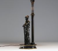 Bronze lamp depicting an antique woman leaning against a column, black marble base.