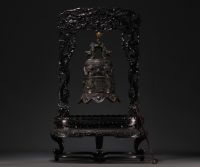 Chine - Cloche en bronze surmontée d'un dragon, supportée par un socle en bois sculpté, vers 1900.