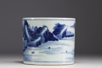 China - A white and blue porcelain brush with landscape decoration.