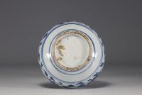 China - A white-blue porcelain vase decorated with a chimera in relief winding around the neck and floral motifs, 18th century.