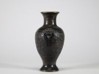 Vase en bronze à décor archaïsant et anses en têtes de lion, Chine Élégant vase en bronze de forme balustre, reposant sur un pied évasé et doté d’un col évasé à bord légèrement ourlé. Le corps est entièrement orné en léger relief d’un décor sinueux de rinceaux et volutes évoquant les motifs archaïques de la période des Royaumes Combattants ou des bronzes rituels Shang-Zho