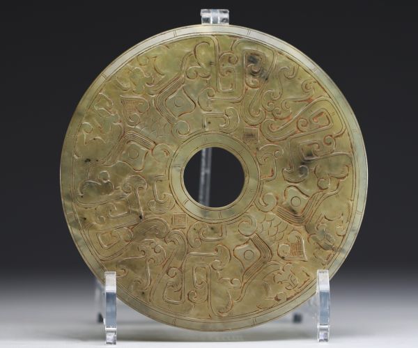 China - Bi jade disc with finely carved archaic motifs.