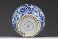 China - A white-blue porcelain baluster vase decorated with flowers, mugwort leaf mark within a double circle, Kangxi.