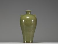 China - A green monochrome porcelain vase with floral decoration in relief, 19th century.