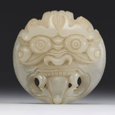 China - Taotie mask in carved green jade.