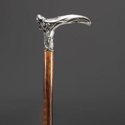 Cane with an Art Nouveau motif, shaft in fine wood, solid silver knob decorated with a woman in bloom.