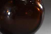 Jean LUCE (1895-1964) - Vase boule en verre fumé à décor géométrique dégagé à l'acide, monogrammé sous la base.