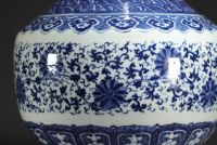 China - Large Hu-shaped vase in blue-white porcelain with floral decoration and bamboo handles, 19th century