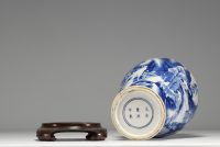 China - White and blue porcelain vase decorated with landscape and characters, wooden base, blue mark under the piece.