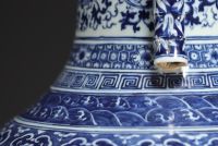 China - Large Hu-shaped vase in blue-white porcelain with floral decoration and bamboo handles, 19th century