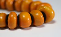 China - Amber necklace composed of twenty-three large pearls separated by felt lozenges.