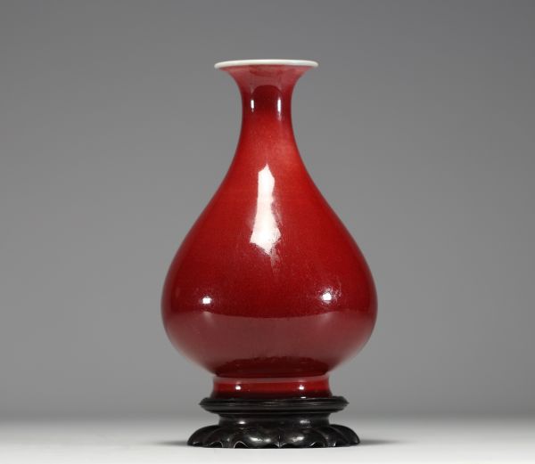 China - Oxblood porcelain vase, wooden base, 19th century.