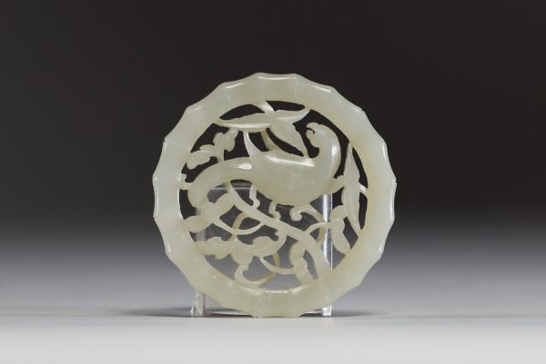 China - Carved jade disc pendant with a magpie on a plum blossom, 18th century.