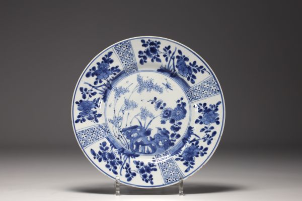 China - A blue-white porcelain plate with floral decoration, Kangxi mark and period.