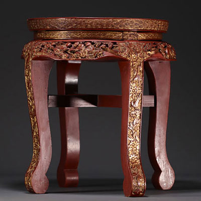 Chine - Petite table d'appoint en laque rouge er or à décor sculpté de personnages et de motifs floraux, fin XIXe siècle.
