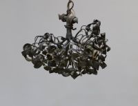 A three-light bronze chandelier with a green patina and opaline glass, representing a mistletoe ball, circa 1900.