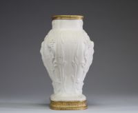 Sèvres - Vase en biscuit, porcelaine à pâte dure monté sur bronze à décor en relief de scènes champêtres, XVIIIème, marque au bleu sous la pièce.