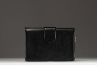 Yves SAINT-LAURENT - Black leather shoulder bag, gold chain and cabochon clasp.