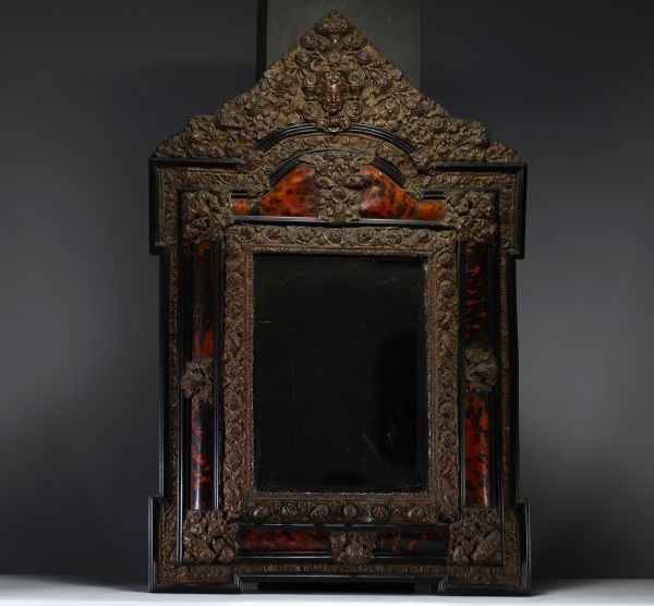 Louis XIV style mirror with repoussé copper and tortoiseshell glazing.