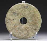 China - Bi jade disc with finely carved archaic motifs.
