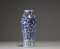 China - A white-blue porcelain vase decorated with flowers and foliage, chilong in relief on the shoulder, 19th century.