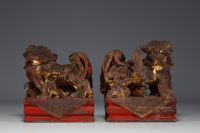 China - Pair of gilded and polychromed carved stone Fô dogs, 18th century.