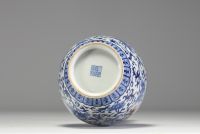 China - A white-blue porcelain vase decorated with a dragon and an iron-red phoenix, mark under the piece, 18th century.