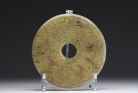 China - Bi jade disc with finely carved archaic motifs.