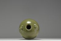 China - A green monochrome porcelain vase with floral decoration in relief, 19th century.