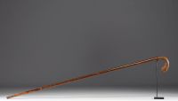 Carved wooden cane with bird's head motif, glass eyes.