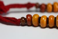 China - Amber necklace composed of twenty-three large pearls separated by felt lozenges.