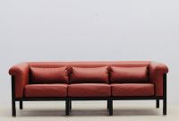Jules WABBES (1919-1974) Three-seater sofa, black lacquered wood and red leather frame, brass base, circa 1960.
