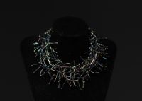 Yves SAINT LAURENT - Parure en perles tubulaires irisées.