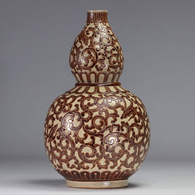 Indochine - vase gourde en céramique émaillé en ocre et vert à décor de motifs feuillagés, 1930