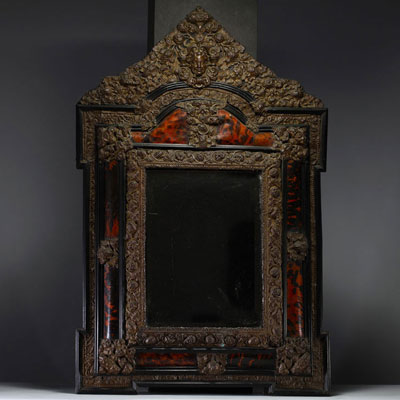 Louis XIV style mirror with repoussé copper and tortoiseshell glazing.