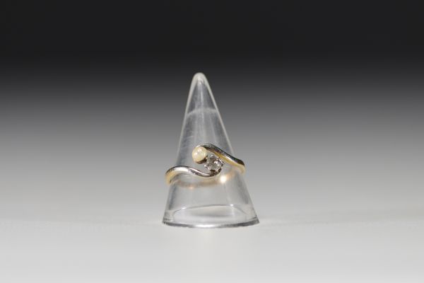 18k gold ring set with a brilliant and a pearl weighing 2.7gr.