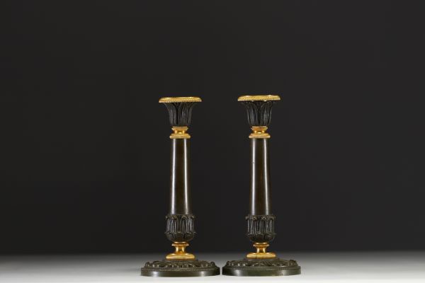 A pair of gilt bronze and brown patina candlesticks, decorated with acanthus leaves, from the Restoration period.