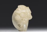 China - Taotie mask in carved green jade.