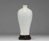 China - An 18th century celadon porcelain vase decorated with flowers in relief.