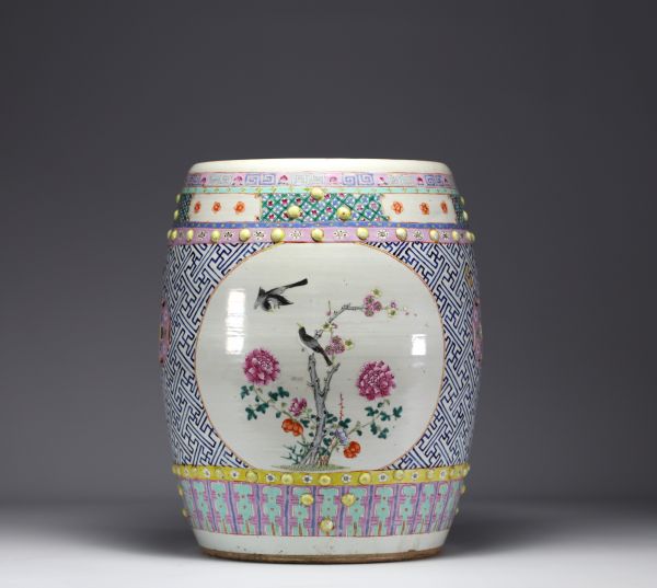 China - A famille rose porcelain stool decorated with peonies and birds in cartouches, circa 1900
