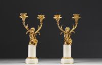 A pair of ormolu candelabra with cherubs and two arms, alabaster base, Napoleon III period.