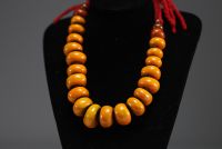 China - Amber necklace composed of twenty-three large pearls separated by felt lozenges.