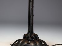DAUM Nancy - Art Nouveau lamp in forged metal with plant decoration, globe in translucent coloured glass, signed.